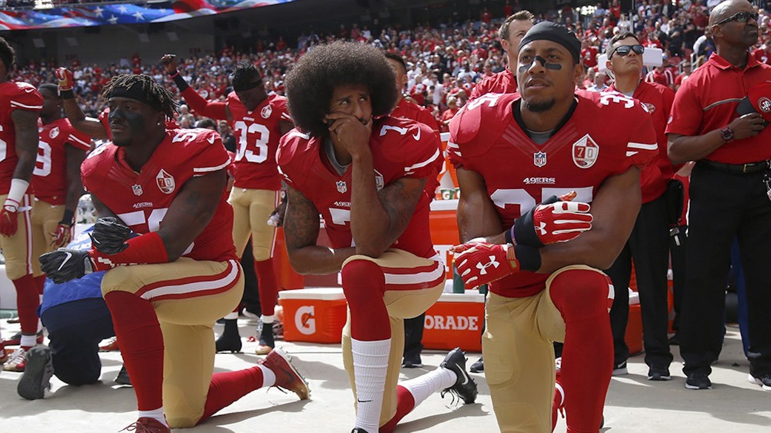 From left, San Francisco 49ers Eli Harold (58), quarterback Colin Kaepernick (7) and Eric Reid (35) kneel during the national anthem before their NFL game against the Dallas Cowboys on Oct. 2, 2016, in Santa Clara, California.