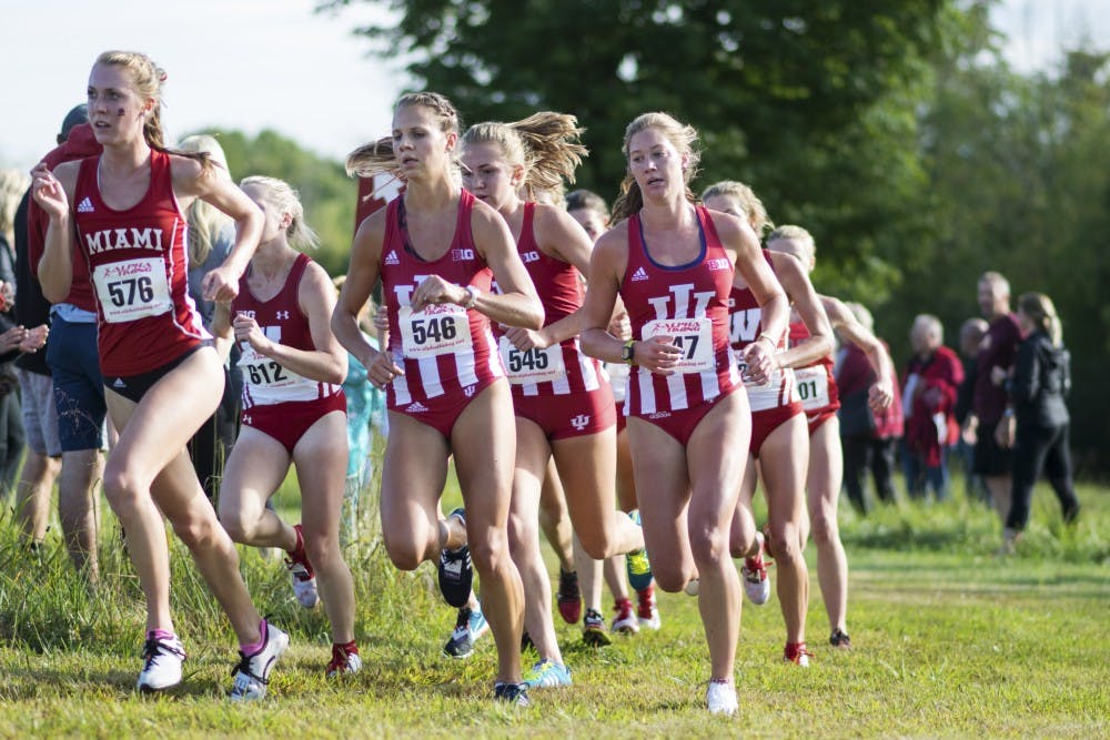 <p>IU women’s cross-country team members round a corner of the 5k course at the IU Open in Aug. 2017. The team finished in seventh at the 2018 Nuttycombe Wisconsin Invitational.&nbsp;</p>
