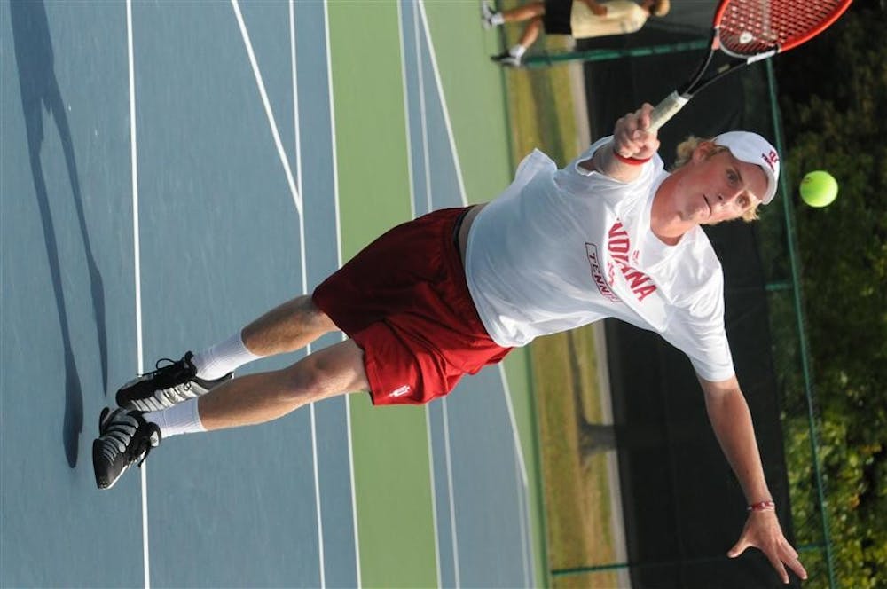 Freshman Tommy Aliber stretches for a forehand on Saturday during the IU Invitational at the Varsity Courts. 