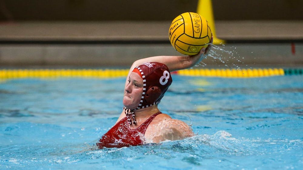 <p>Then-junior center Izzy Mandema makes a pass April 2, 2021, at the Counsilman-Billingsley Aquatic Center. Indiana went 2-1 against three different California schools over the weekend.</p>
