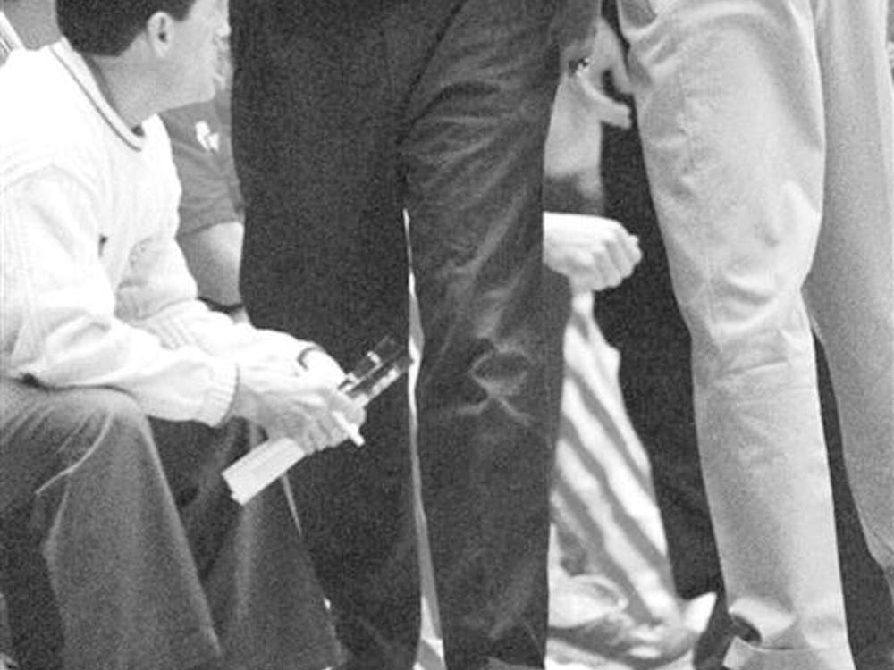 Indiana University men's basketball coach Bobby Knight, left, is restrained by his son, Pat Knight, as he screams at the referees who called a technical foul on him during the first half against Ohio State in Bloomington, Ind., Saturday, Feb. 19, 2000. 