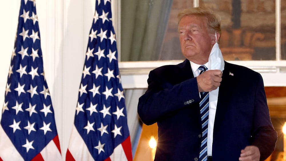 President Donald Trump removes his mask upon return to the White House from Walter Reed National Military Medical Center on Oct. 5 in Washington, D.C. Trump spent three days hospitalized for the coronavirus.