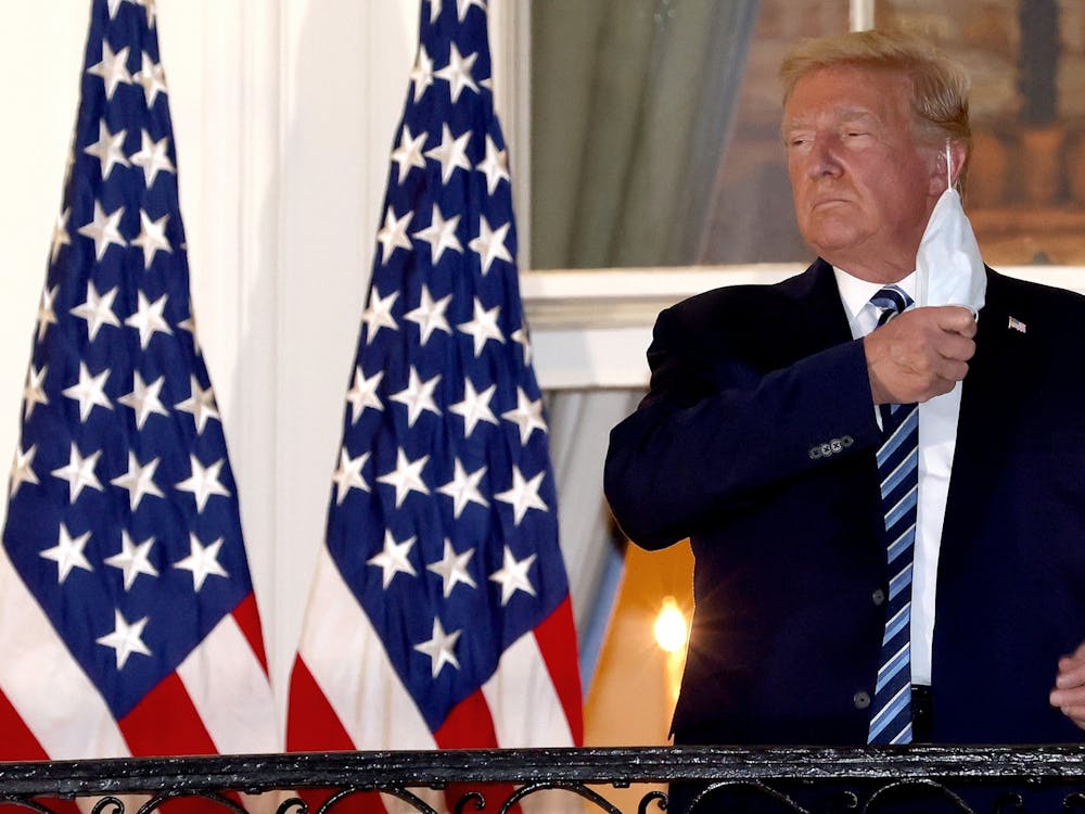 President Donald Trump removes his mask upon return to the White House from Walter Reed National Military Medical Center on Oct. 5 in Washington, D.C. Trump spent three days hospitalized for the coronavirus.