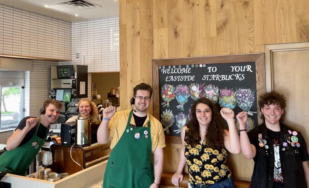 <p>Employees at the Bloomington Eastside Starbucks raise their fists in support of the store&#x27;s unionization efforts ﻿in June, 2023. Workers at the Bloomington Eastside Starbucks voted unanimously Tuesday to officially join Starbucks Workers United, a collective of more than 340 U.S. Starbucks partners across the country. </p>