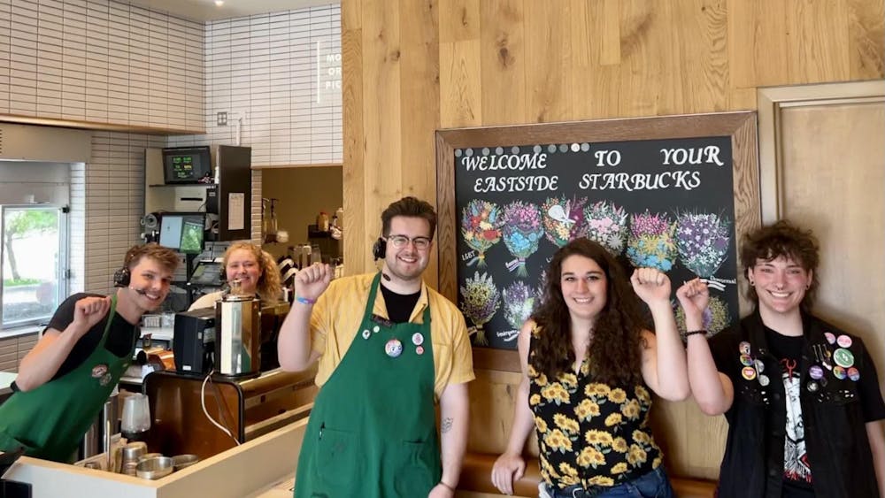 Employees at the Bloomington Eastside Starbucks raise their fists in support of the store&#x27;s unionization efforts ﻿in June, 2023. Workers at the Bloomington Eastside Starbucks voted unanimously Tuesday to officially join Starbucks Workers United, a collective of more than 340 U.S. Starbucks partners across the country. 
