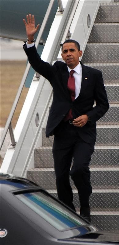 President Barack Obama waves as he steps off Air Force One upon his arrival in South Bend, Ind.