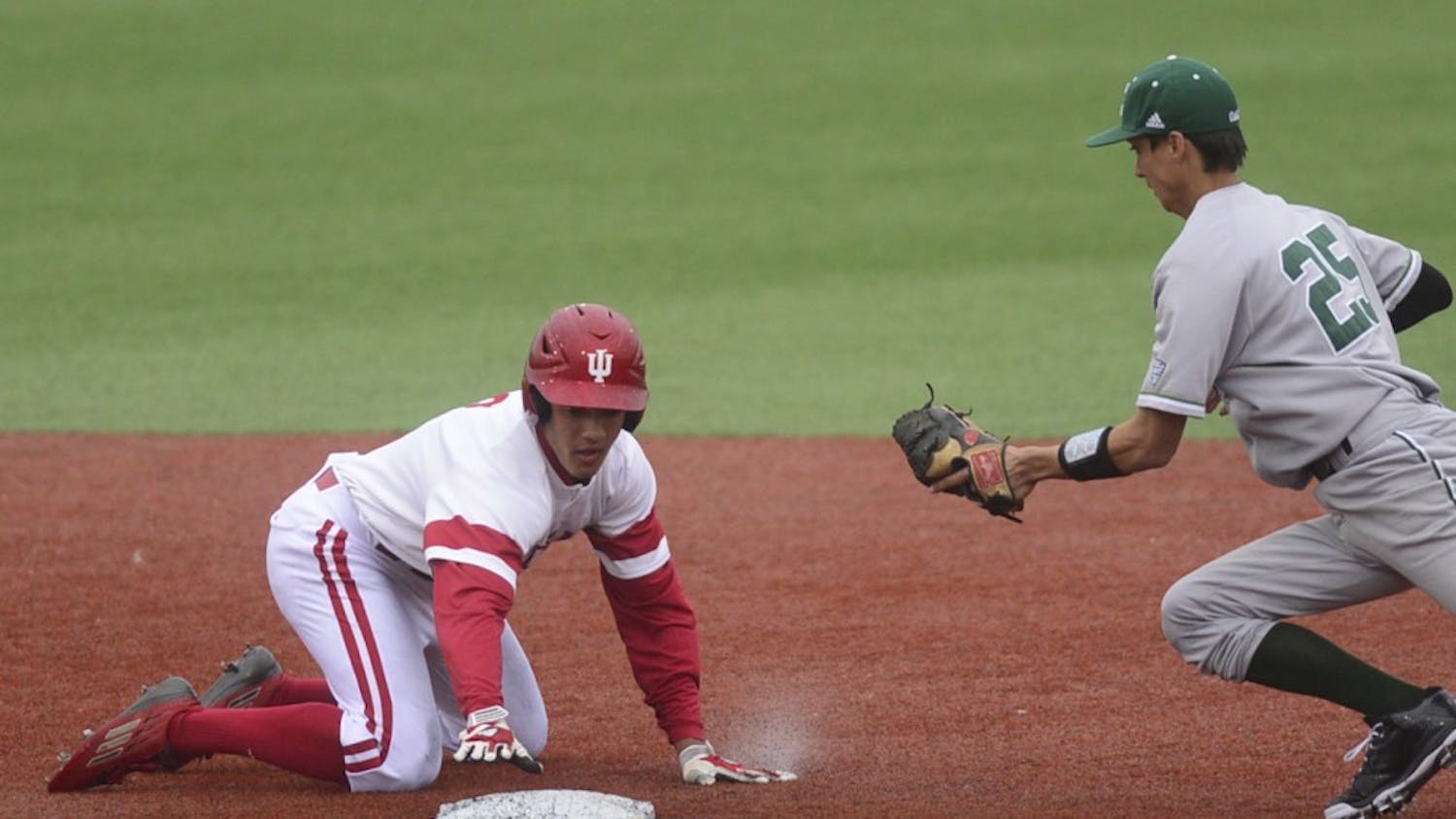 Freshman Isaiah Pasteur reaches for second base to avoid a tag during IU's home opener against Eastern Michigan on Tuesday at Bart Kaufman Field.