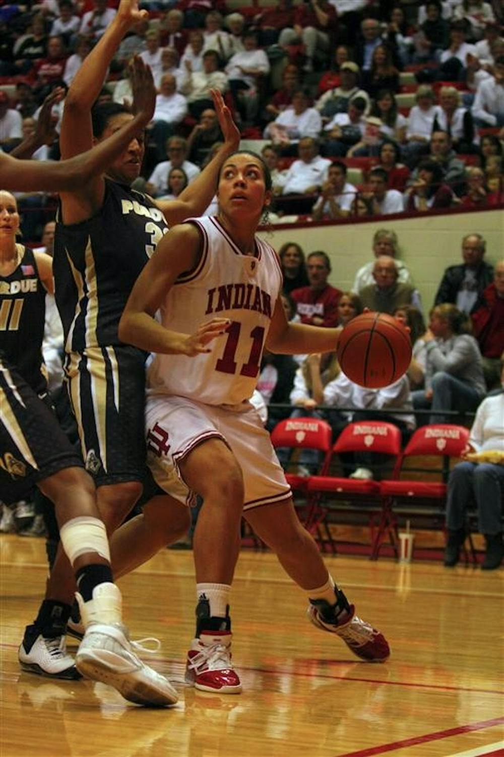 Senior Forward Whitney Thomas ducks under Purdue defense to make a jumpshot to the basket. After a very close first half, the Hoosiers came out on top, with a 71-57 victory against Purdue Monday evening at Assembly Hall. 