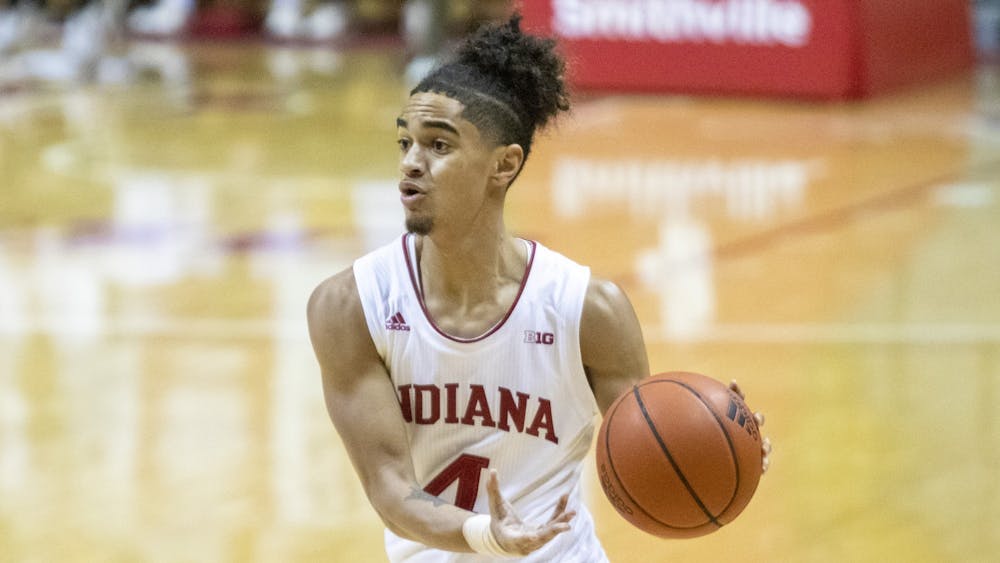 Freshman guard Khristian Lander dribbles the ball Feb. 27 in Simon Skjodt Assembly Hall. Lander entered the transfer portal Friday, becoming the sixth Hoosier to do so since the firing of former head coach Archie Miller.