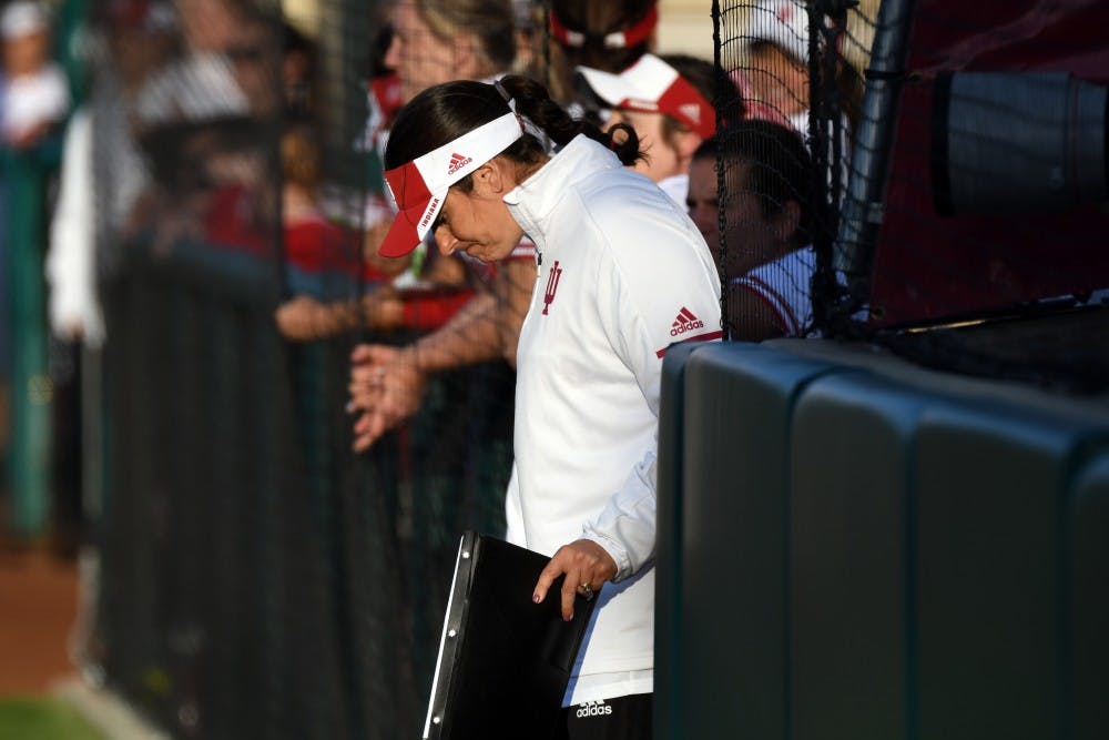 <p>IU Coach Shonda Stanton bows her head during the game against Michigan on March 27 at Andy Mohr Field.</p>