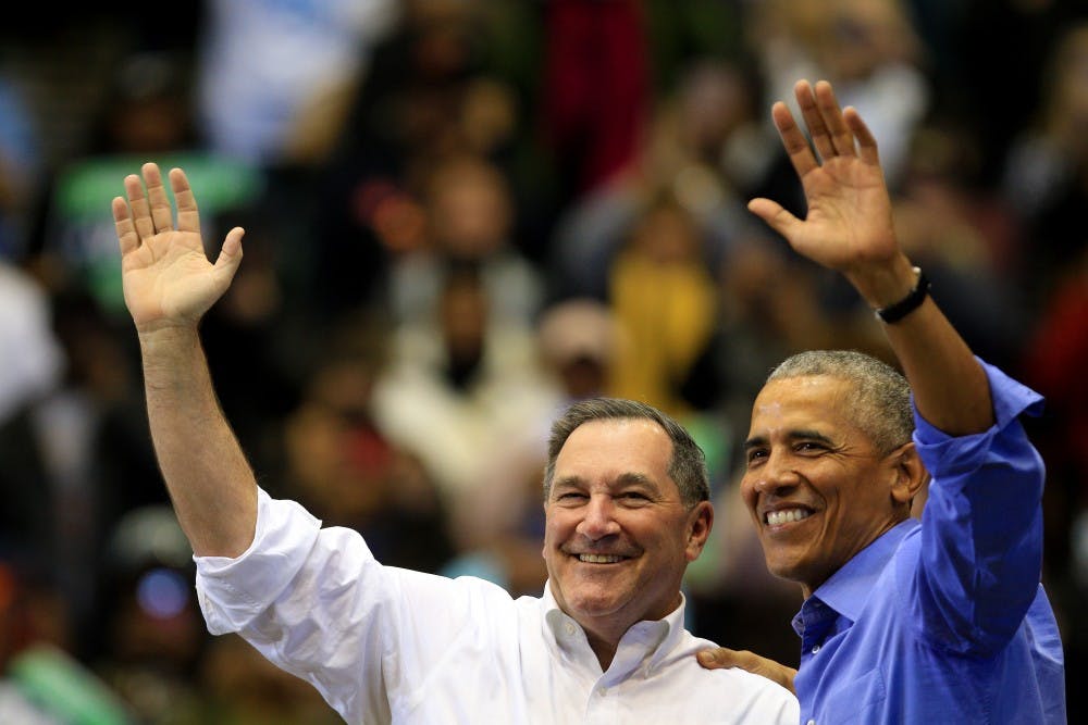<p>Former President Obama and Sen. Joe Donnelly, D-Indiana, hug and wave to the crowd after a rally Nov. 4 in Gary, Indiana. Obama traveled to Gary with Donnelly to encourage people to vote in the midterm elections.&nbsp;</p>