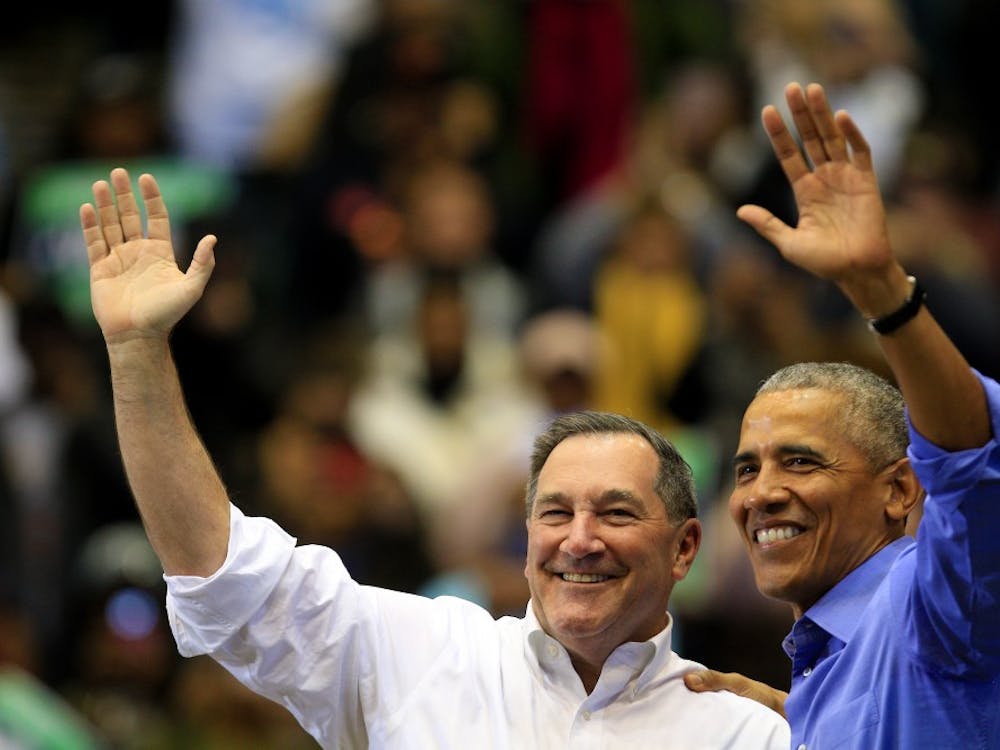 Former President Obama and Sen. Joe Donnelly, D-Indiana, hug and wave to the crowd after a rally Nov. 4 in Gary, Indiana. Obama traveled to Gary with Donnelly to encourage people to vote in the midterm elections.&nbsp;