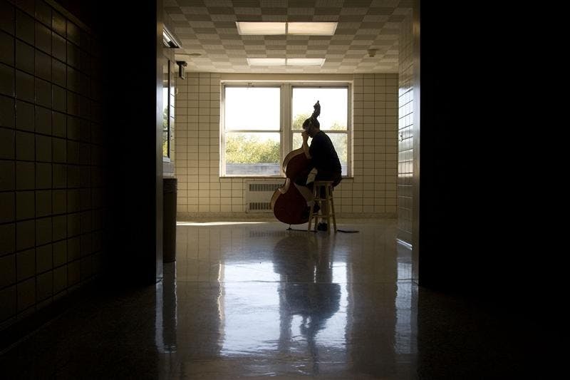 Graduate student Noah Reitman practices his double bass, which is one octave lower than a cello, Wednesday in the Jacobs School of Music.  Reitman's double bass was made in Mirecourt, France 150 years ago.  