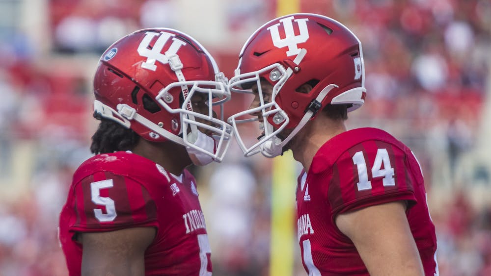 Then-graduate running back Stephen Carr and then-redshirt junior quarterback Jack Tuttle celebrate Carr&#x27;s touchdown Oct. 16, 2021, at Memorial Stadium. Indiana will face Western Kentucky University at noon Saturday in Bloomington.