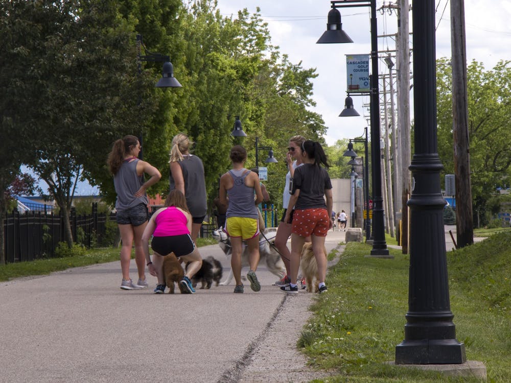 Dog walkers congregate May 28 on the B-Line Trail. IU professors Christina Ludema and Brian Dixon said the safest space to gather with others is outside.