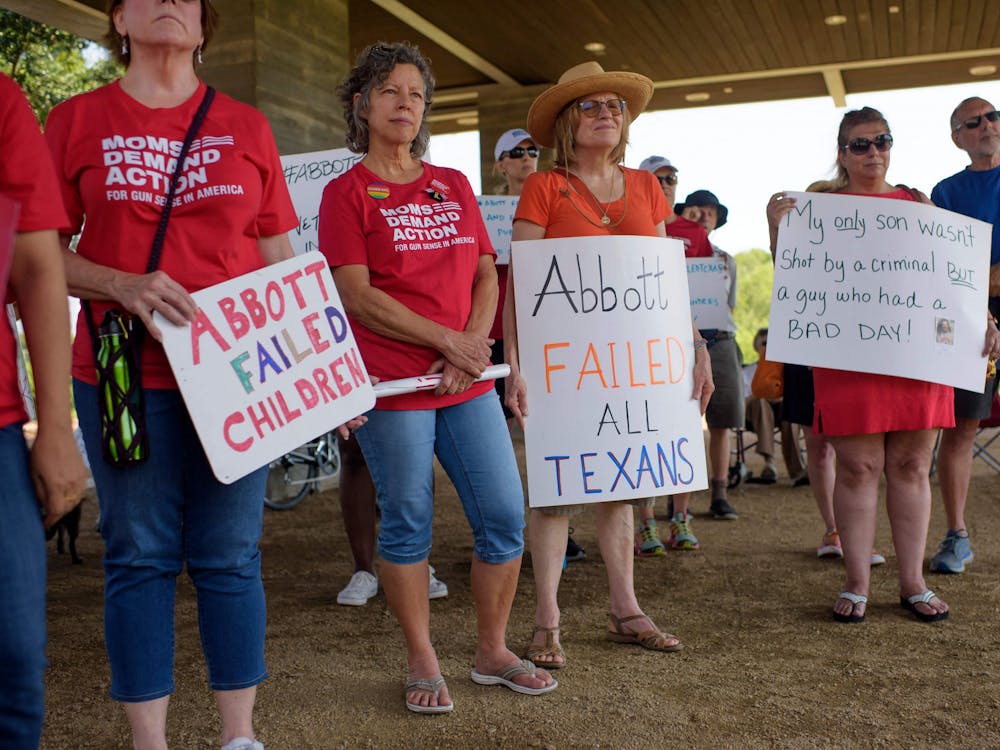 People hold signs during a &quot;Moms Demand Action&quot; protest June 17, 2021, at Buffalo Bayou Park in Houston after a new Texas gun law signed by Gov. Greg Abbott which allows Texans to carry firearms in public without a permit. 