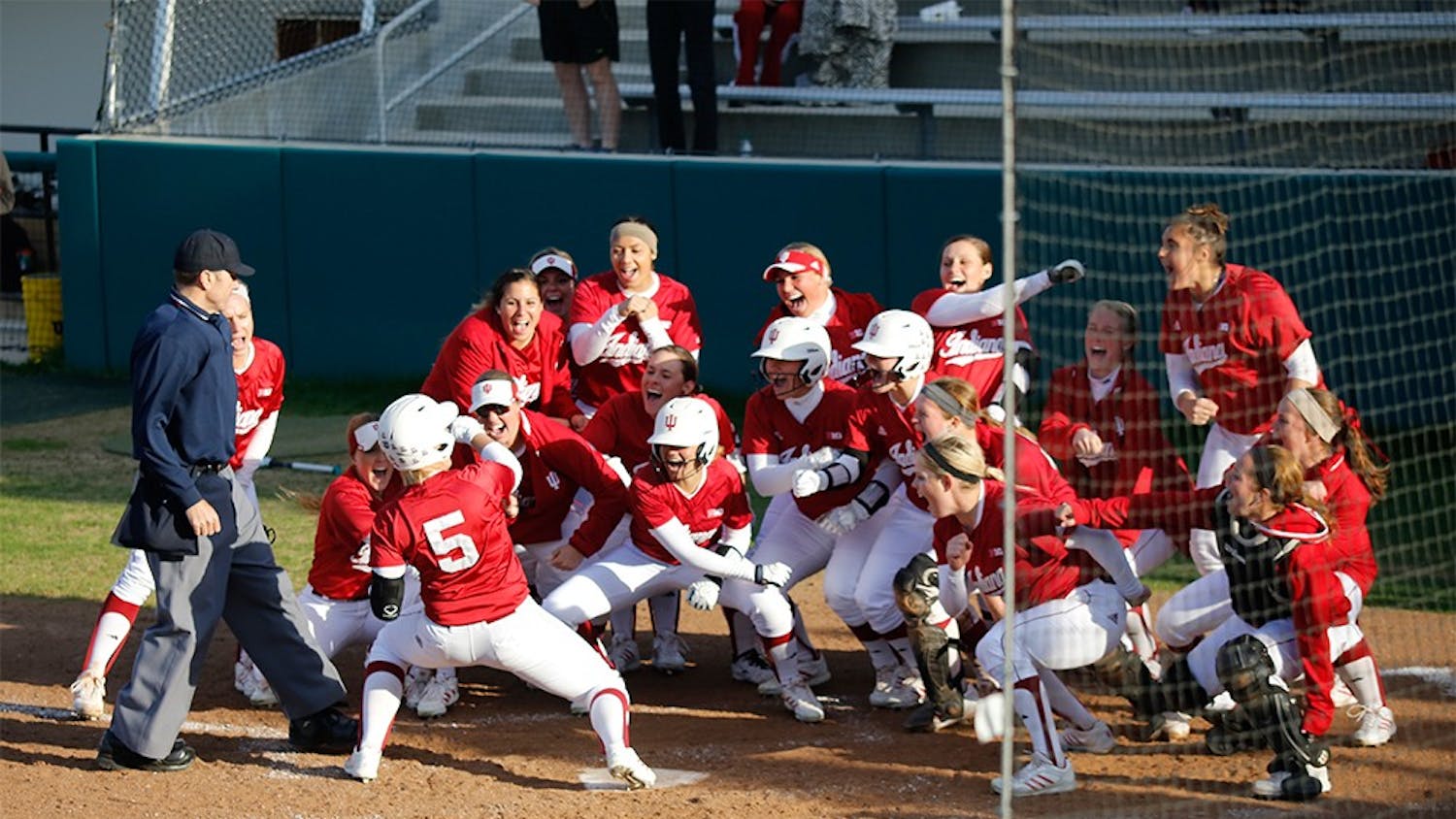 Members of the IU Softball team celebrate after freshman Mena Fulton hit a 3-run home run during the last inning of IU's game against Purdue April 22, 2015 at the Andy Mohr Field; resulting in a 6-3 win for the hoosiers.