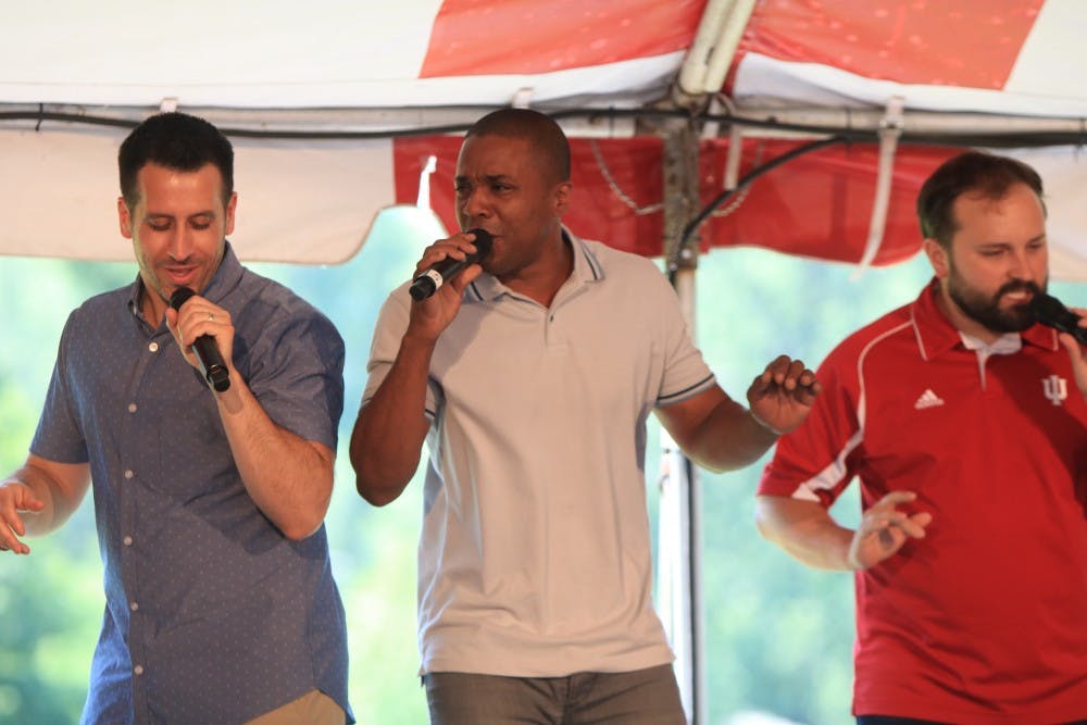 <p>Straight No Chaser members Jerome Collins, Walter Chase and Tyler Trepp dance while performing June 9 at the IU Alumni Association luncheon and meeting outside the DeVault Alumni Center. Straight No Chaser will perform at 8 p.m. Dec. 13 at the IU Auditorium.&nbsp;</p>
