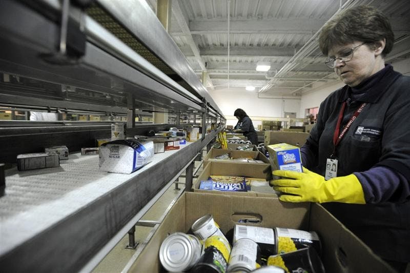 Mary Tock checks for peanut products at the Greater Chicago Food Depository, the city's clearinghouse for nearly 600 local food banks Tuesday in Chicago. Food pantries are chucking thousands of pounds of food containing peanut products tainted from the salmonella outbreak  a particularly painful process as food banks struggle to meet a growing demand to feed families in a floundering economy. 