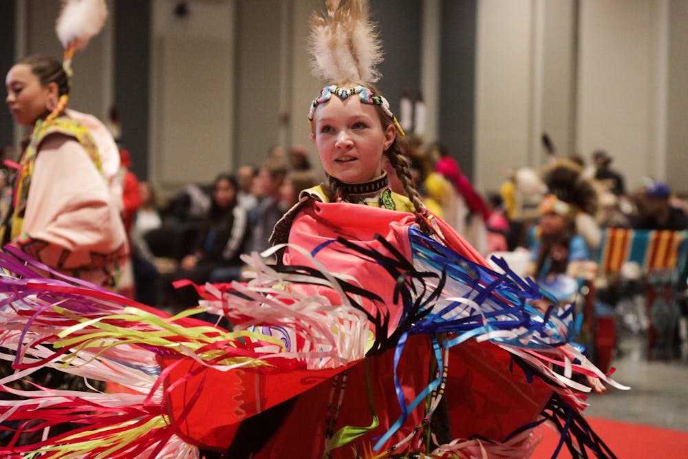 <p>A girl dances during the IU Traditional Powwow on April 9, 2022, at the Marching Hundred Hall. A group of women performed a traditional scarf dance.  </p>