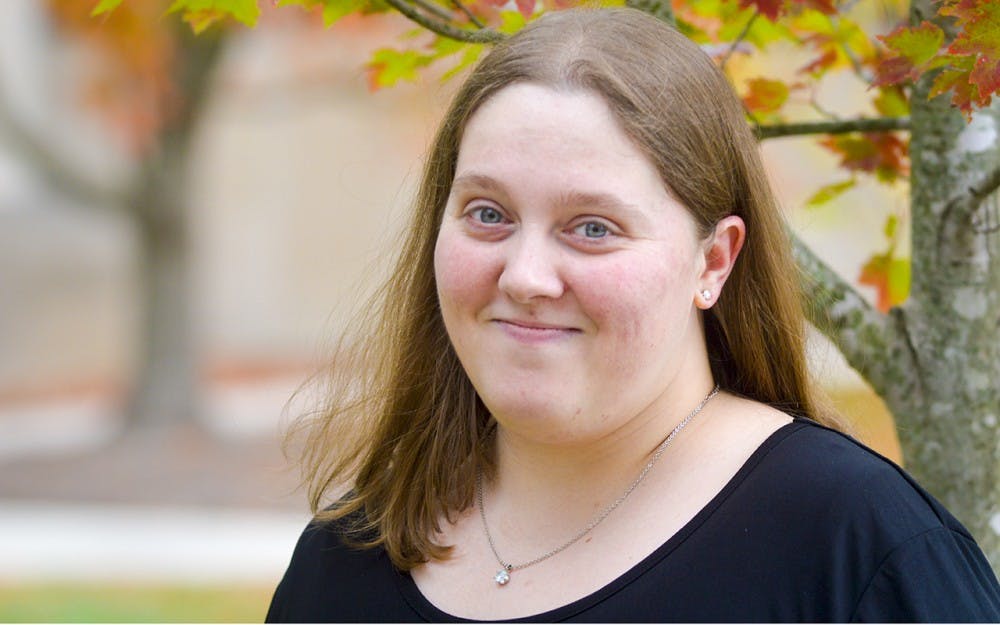 Full-time IU student and mom Sheryl Stevens takes a break from her Intro to German Culture class Monday afternoon to do a quick photoshoot outside of the Global & International Studies Building. 