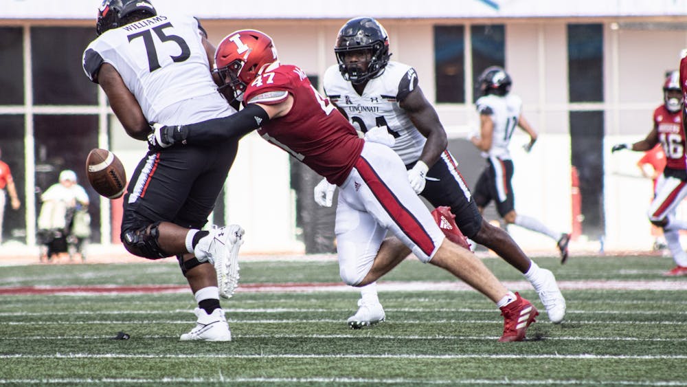 Senior Micah McFadden steals the ball from a Cincinnati Bearcats player of the ball on Sept. 18, 2021, at Memorial Stadium. McFadden was drafted by the New York Giants as the 146th pick in the 2022 NFL Draft on Saturday.