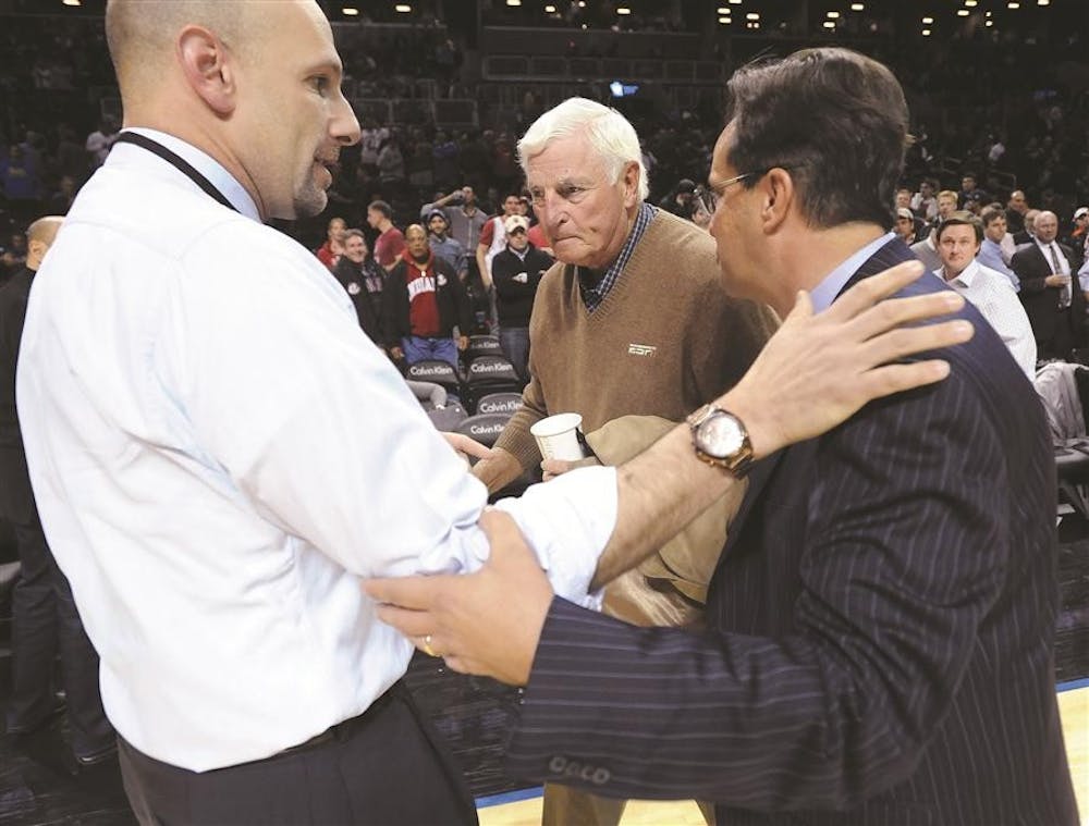 <p>Head coach Tom Crean runs over to former head coach Bob Knight to shake his hand after the Indiana Georgia Progressive Legends Classic tournament game at the Barclay Center in Brooklyn, NY. Monday, Nov. 19, 2012. ESPN analyst Dan Shulman is at left.</p>
