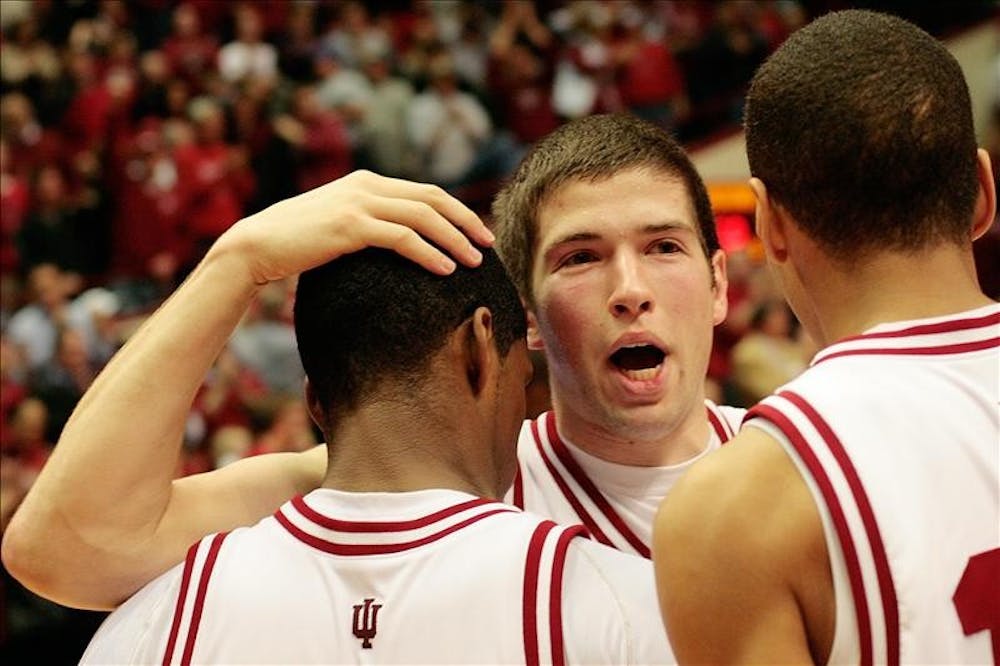 Freshman guard Matt Roth hugs junior guard Devan Dumes, left, and freshman guard Verdell Jones, right, following the Hoosiers 68-60 win over Iowa Wednesday night at Assembly Hall. The win ended an 11 game losing streak and was the Hoosiers first Big Ten victory.