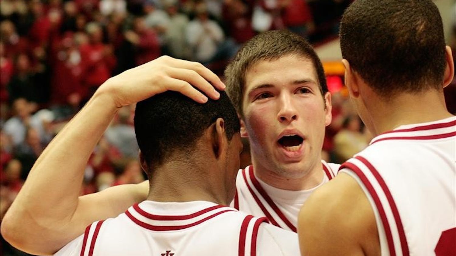 Freshman guard Matt Roth hugs junior guard Devan Dumes, left, and freshman guard Verdell Jones, right, following the Hoosiers 68-60 win over Iowa Wednesday night at Assembly Hall. The win ended an 11 game losing streak and was the Hoosiers first Big Ten victory.
