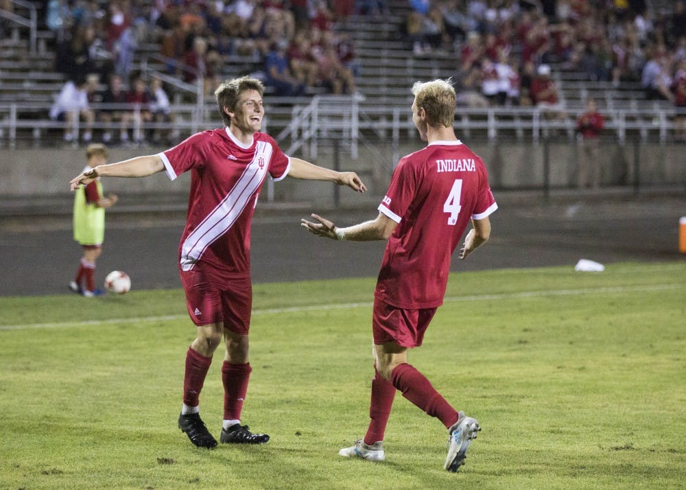 <p>Senior Trevor Swartz celebrates with sophomore A.J. Palazzolo after IU's goal Sept. 7 at Bill Armstrong Stadium. Swartz was awarded Big Ten and national weekly honors Tuesday.</p>