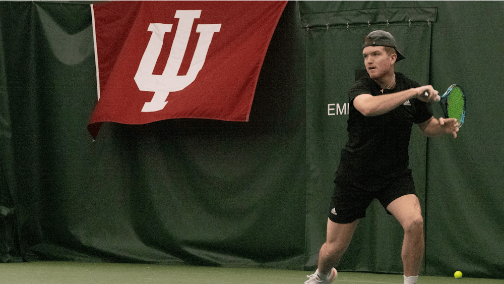 Senior Patrick Fletchall returns a serve against the University of Southern Indiana on Feb. 12, 2023, at the IU Tennis Center.