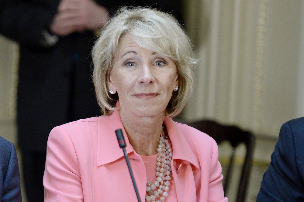 <p>Secretary of Education Betsy DeVos listens as President Trump speaks during a strategic and policy discussion with CEOs April 11 in Washington, D.C. After the Department of Education announced changes to sexual misconduct guidance, a group of more than 40 students and alumni signed a letter to IU President Michael McRobbie, asking the University “stand with survivors and show the country that this university cares about its students.”</p>