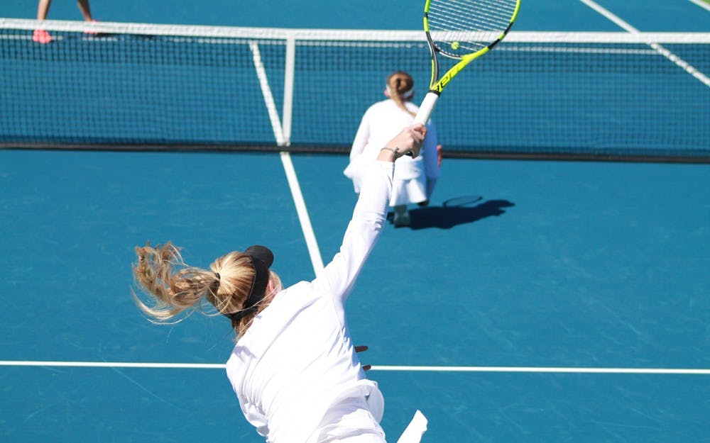 Sophomore Madison Appel serves the ball in a doubles match against Illinois&nbsp;on Friday afternoon. Appel and senior partner Kim Schmider gave the Hoosiers a 6-3 doubles victory, though the team fell to the Fighting Illini, 6-1.