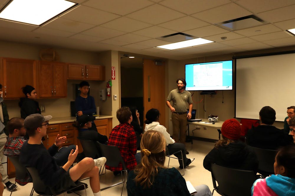 <p>Grad student Joe Stoica asks about proposed route changes to Bloomington transit Dec. 11 at Tulip Tree Apartments activity room. The proposed route changes would start August 2020. </p>