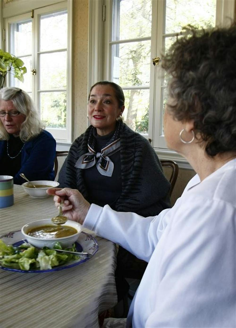 Sitting in between First Lady Laurie Burns McRobbie to the left, and faculty member Elaine Finley to her right, Faculty Member Diane Jung discusses how certain foods were chosen while eating lunch, Friday at the Bryan House on the fifth day of the Food Stamp Challenge.