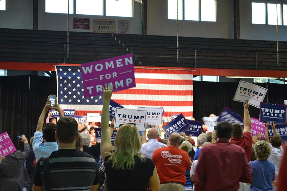 Supporters for Lt. Gov. Eric Holcomb's bid for governor cheer and wave signs during a campaign event in Jeffersonville, Indiana on Sunday night.