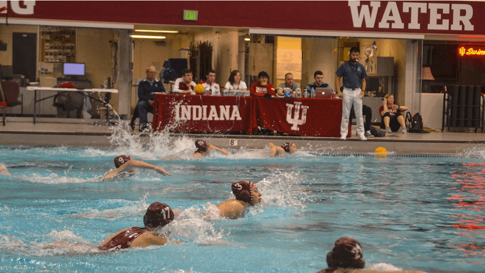Members of the women’s water polo team swim to the center of the court to start the quarter March 7, 2020, in the Counsilman-Billingsley Aquatics Center. The IU water polo team lost two home matches this weekend to the University of Southern California. 