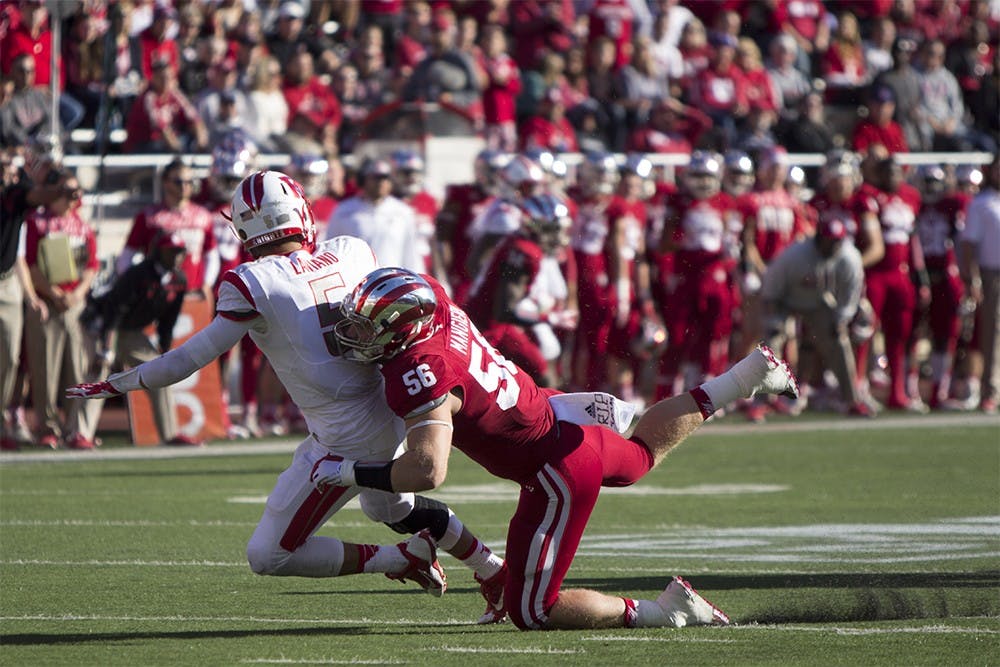 Defensive end Nick Mangieri takes down Rutgers quarterback Chris Laviano in the first half of game play at Memorial Stadium on Oct. 3.