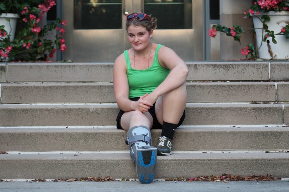 <p>Deborah Alix, a senior majoring in theatre and drama, rests her fractured foot Aug. 28 on the steps outside the Neal-Marshall Black Culture Center. Her doctor believes she should be out of the boot by October.<br>
&nbsp;</p>