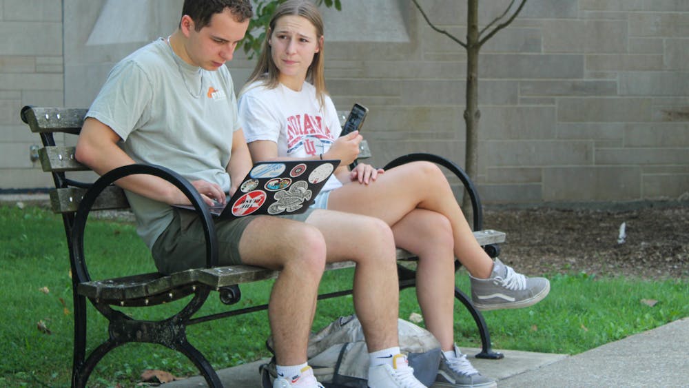 Students sit on a bench outside Woodburn Hall on September 6, 2023. IU partnered with Stellic in 2022 to launch an online student success platform in fall 2024.