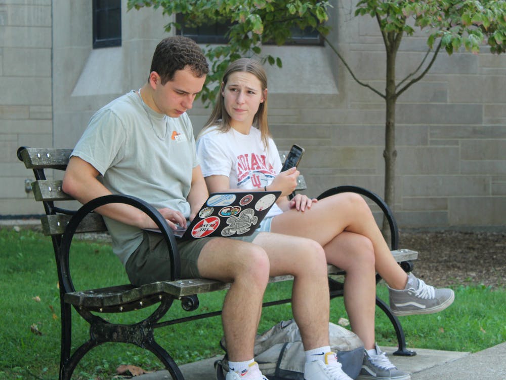 Students sit on a bench outside Woodburn Hall on September 6, 2023. IU partnered with Stellic in 2022 to launch an online student success platform in fall 2024.