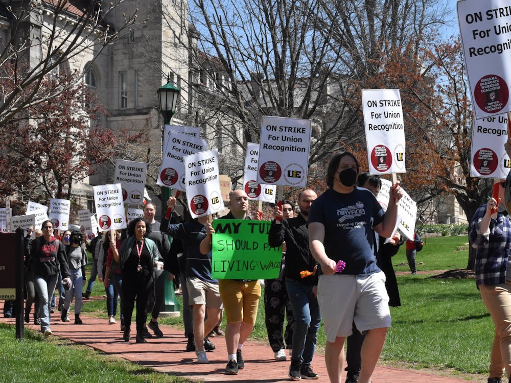 Strikers march in front of Franklin Hall April 13, 2022, during the grad worker strike. IU is reducing the number of future doctoral student admissions to account for the increased stipend for graduate worker wages.