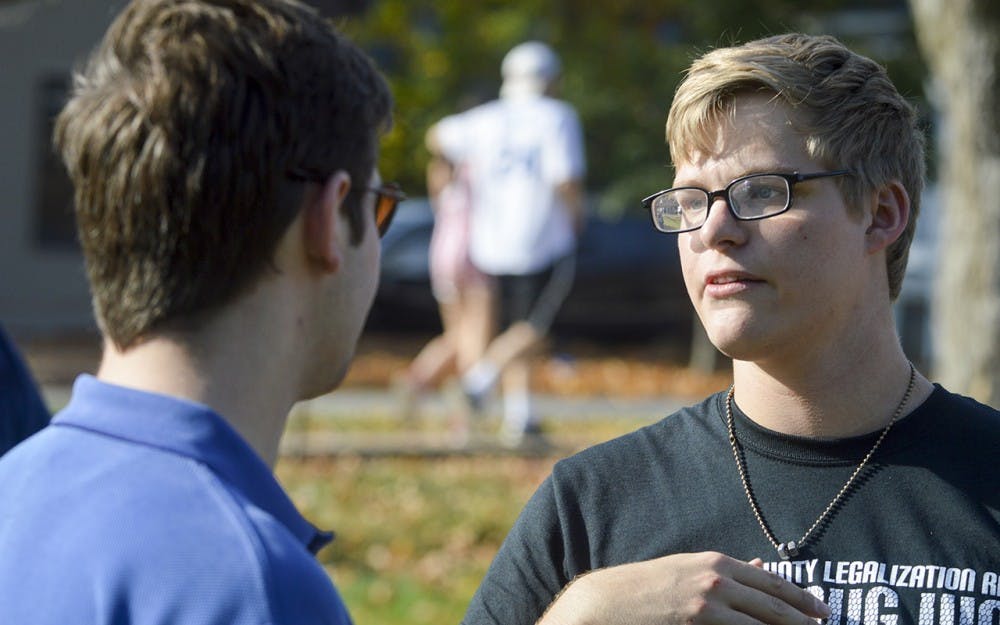 District 61 Indiana State House of Representatives candidate Drew Ash and Against PROHIBITION President Brandon Lavy discuss their views on drug reform during the Weed Legislation Rally on Saturday afternoon in Dunn Meadow. Ash states that he is in favor of the decriminalization of marijuana because of the black market that weed laws create. 