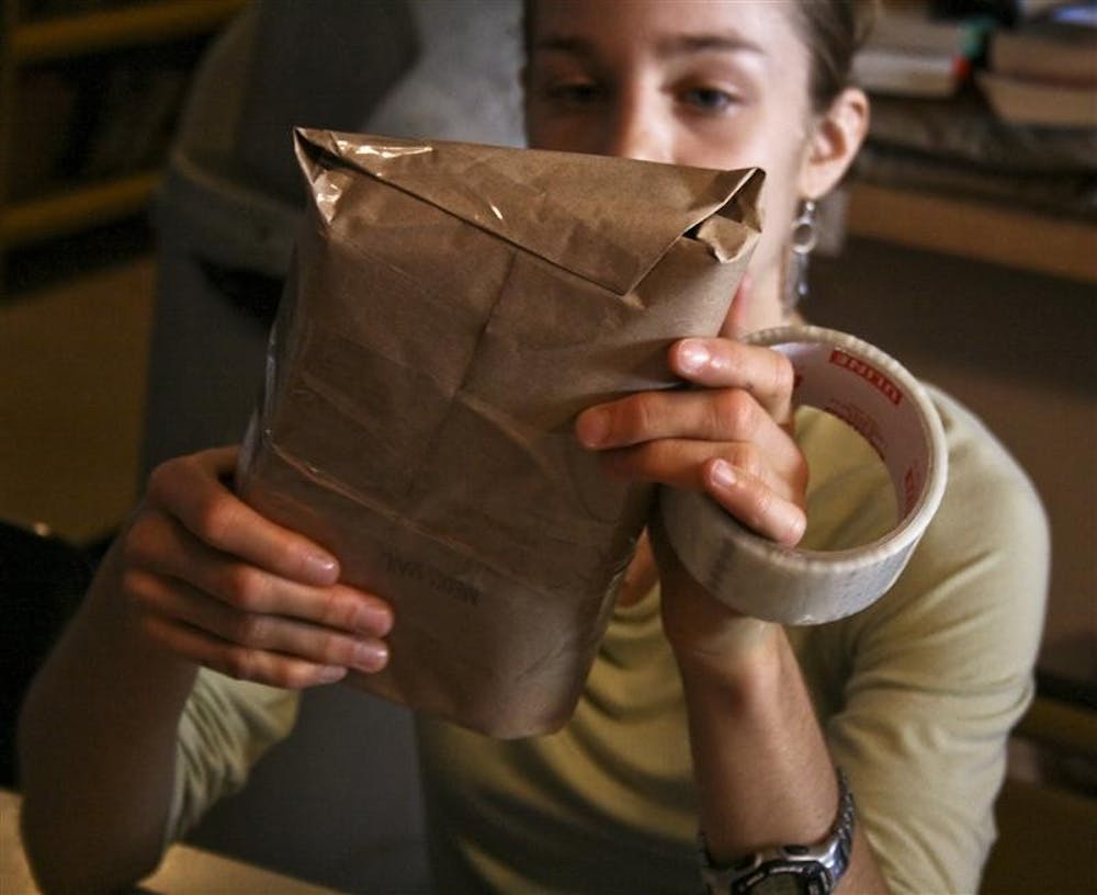 Junior Kimberly Kopecky packages books to be sent to a prison facility in Greencastle, Ind. on Sept. 29 at the Midwest Pages for Prisoners office. The program fills orders for prisoners across the Midwest, Arizona and Florida.