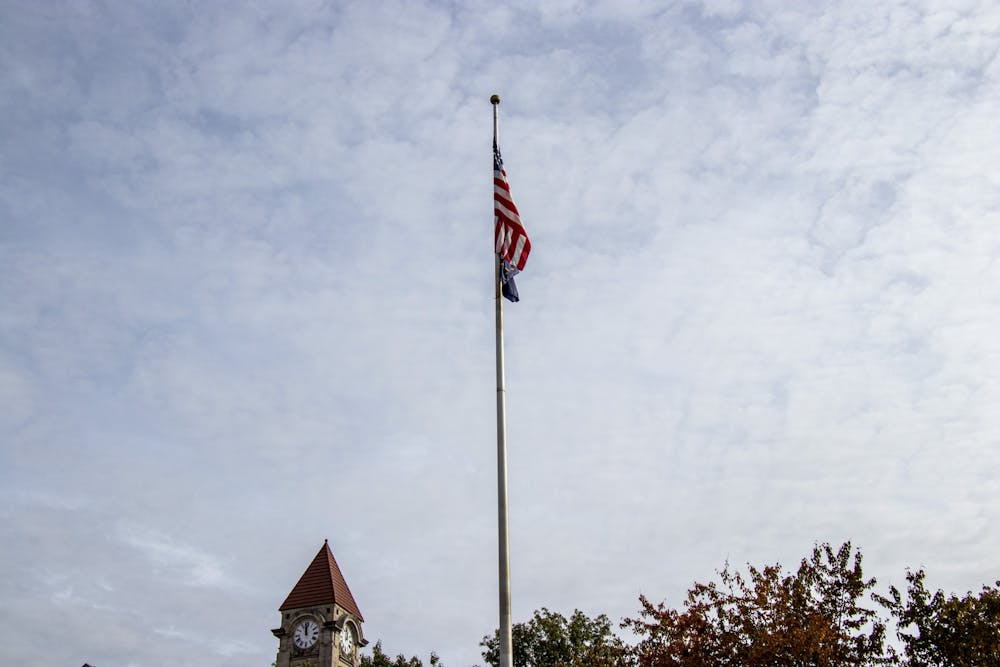<p>An American flag and an Indiana flag are attached to a flag pole on Nov. 1, 2021, outside the Student Building. Flags across all IU campuses are lowered to half-staff following the direction of the U.S. president or Indiana governor.</p>