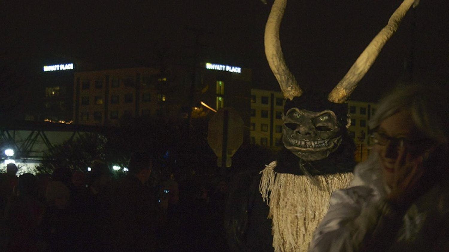 People dress up as demonic followers of Krampus, the "Bad Santa," during the 2014 Krampus parade in downtown Bloomington. The creatures walked down Madison Street and taunted people wearing "Naughty" stickers.