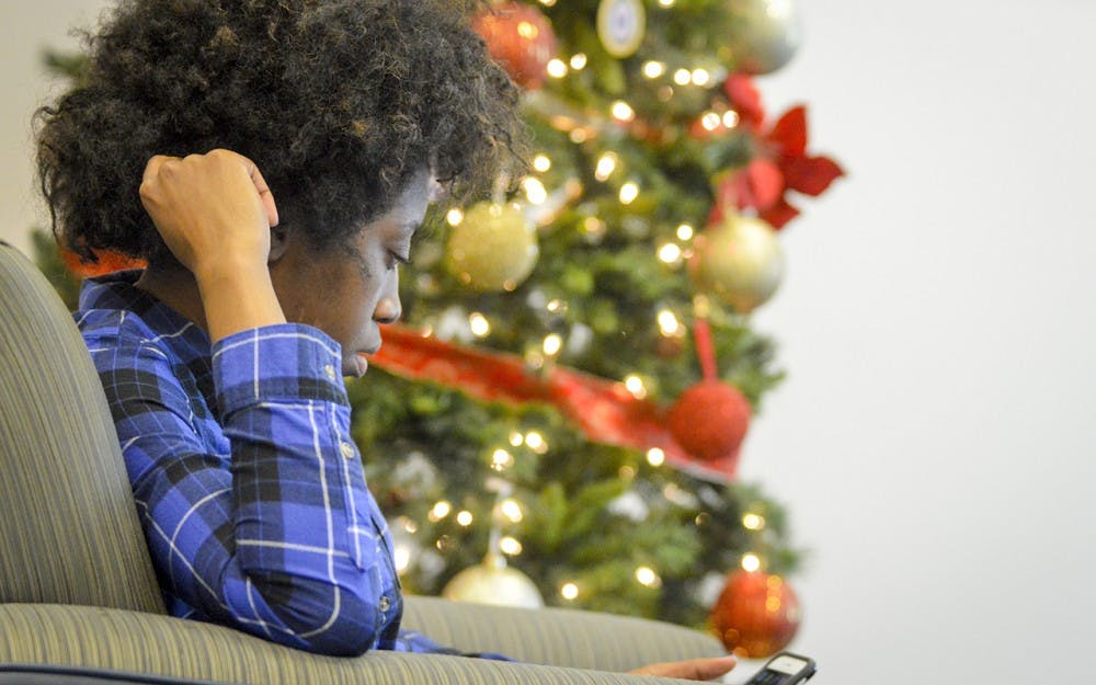 Junior Sydney Smith enjoys food with friends during the week-long Kwanzaa celebration Wednesday afternoon at the Neal Marshall Black Culture Center.