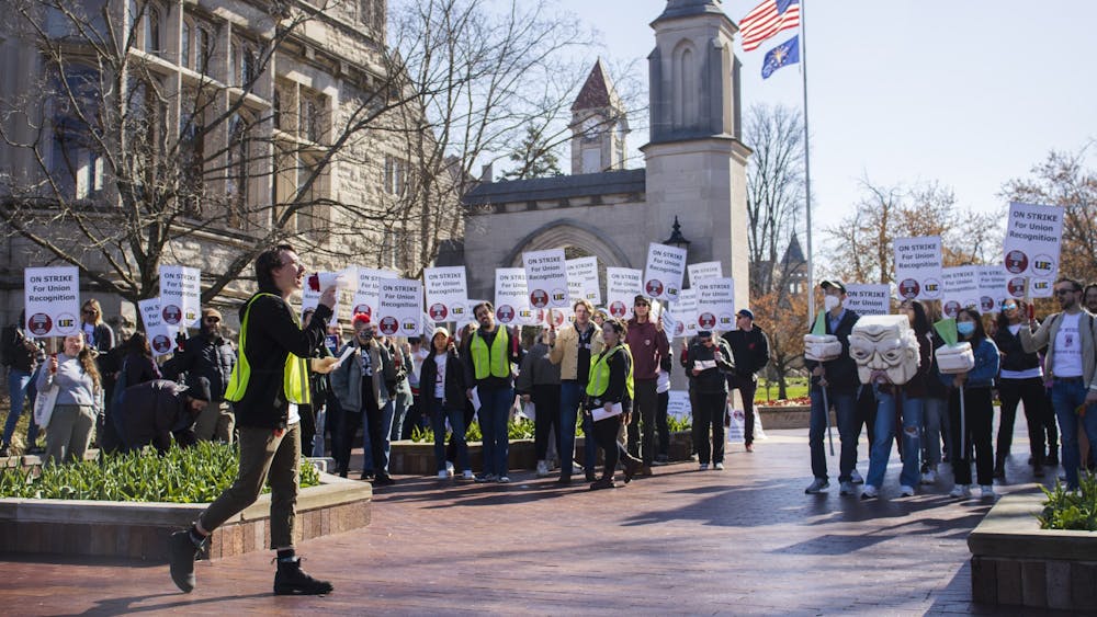 Doctoral candidate Pat Wall leads chants with at Sample Gates on April 14th, 2022. &quot;They can recognize our union and negotiate with us over our contracts,&quot; Wall said of the outcome of the strike.