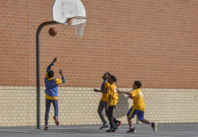 Students play a game of basketball during an after-school program Mach 10 at Murray Hill Middle School in Laurel, Maryland.