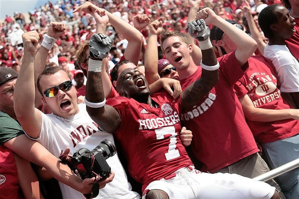 Senior corner back Ray Fisher celebrates with the student section following the Hoosiers 23-19 win over Western Michigan at Memorial Stadium.